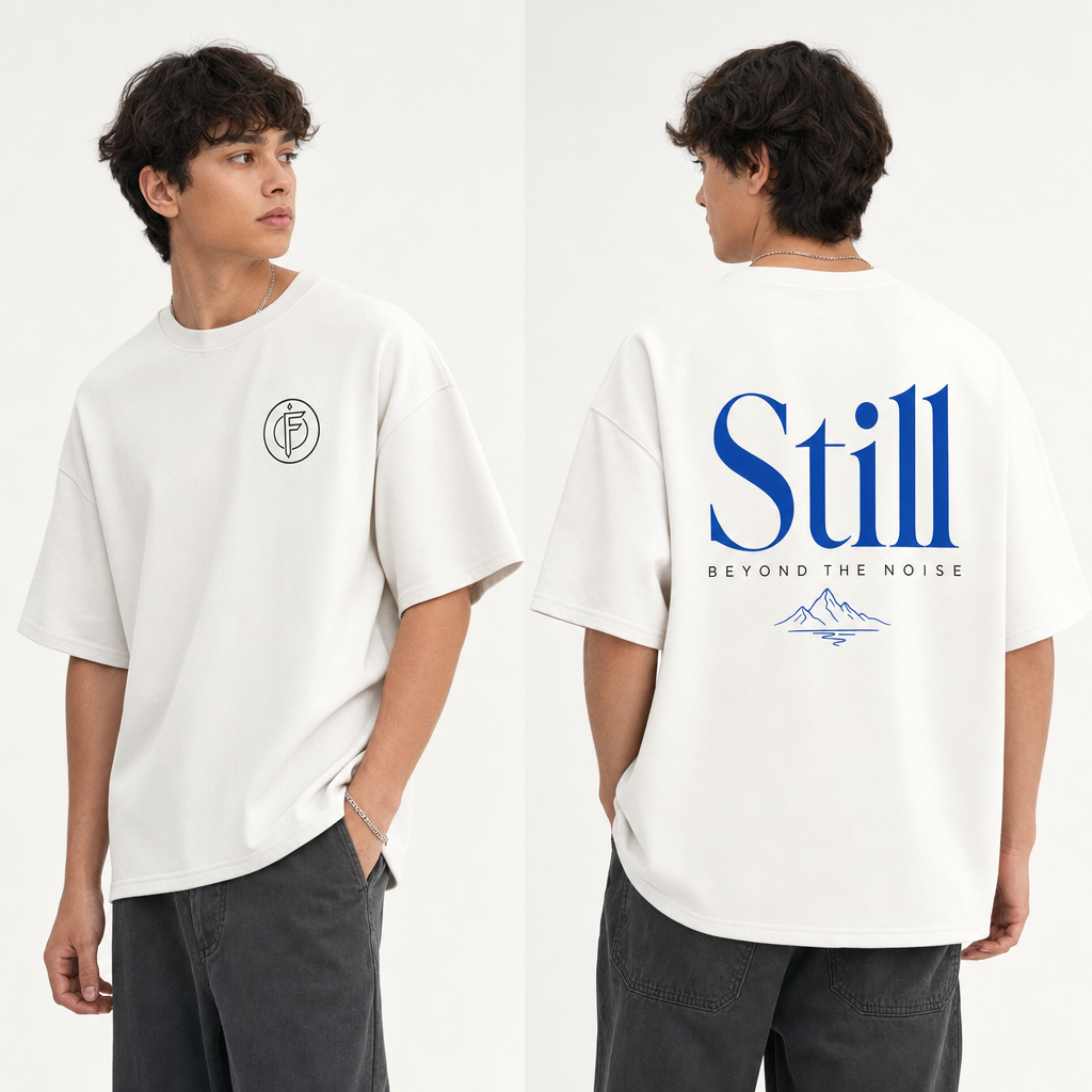 Editorial studio photo of a model wearing an oversized heavyweight t-shirt with a STILL BEYOND THE NOISE graphic, front and back views, relaxed streetwear fit, clean studio background.