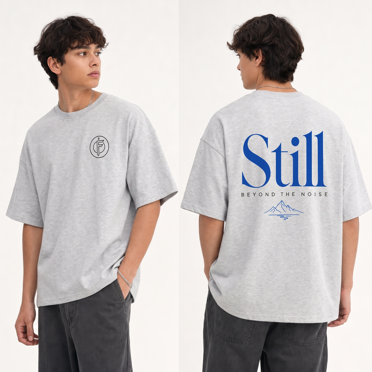 Editorial studio photo of a model wearing an oversized light heather grey Icy Rock heavyweight t-shirt with the STILL BEYOND THE NOISE graphic, front and back views, relaxed streetwear fit, clean studio background.